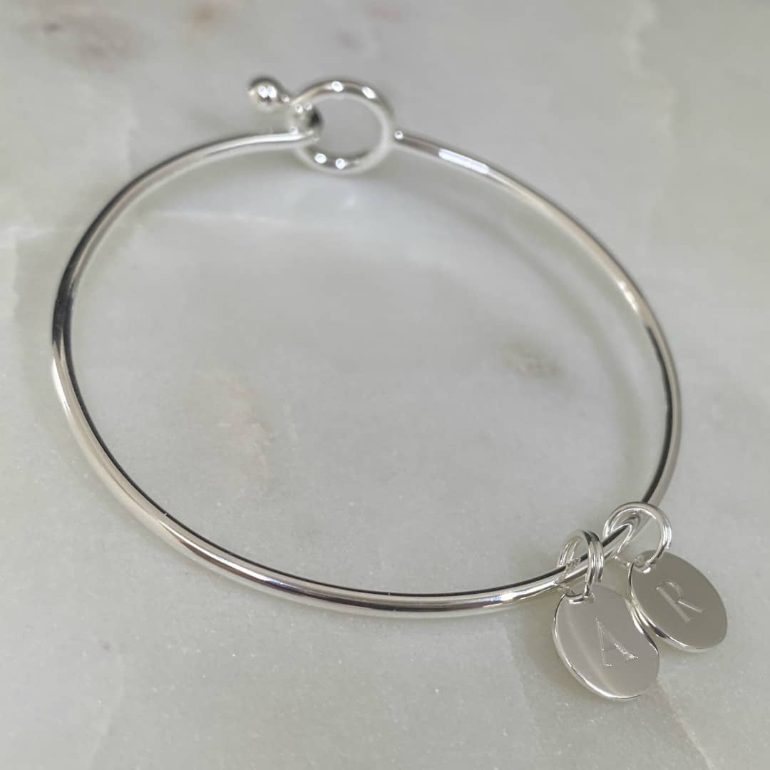 sterling silver opening bangle with mini disc pendant engraved with initials