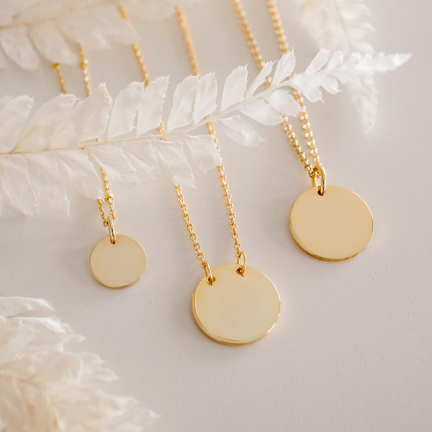 3 styles of yellow gold disc necklaces engraved